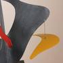 This work continues the current mode in which I am working A sculptural framework in sheet metal, with burst of colour and at least one kinetic element. The edges of the sculpture define space in the same way that  a line drawing does.
The main body of the sculpture has a brush textured finish, blue grey in colour , and this contrasts with the high lacquer finishes of the coloured elements. Edition 2/4
