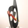 This work continues the current mode in which I am working A sculptural framework in sheet metal, with burst of colour and at least one kinetic element. The edges of the sculpture define space in the same way that  a line drawing does.
The main body of the sculpture has a brush textured finish, blue grey in colour , and this contrasts with the high lacquer finishes of the coloured elements. Edition 2/4