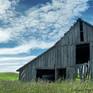 Close up of partial barn and texture in sky.