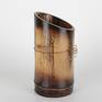 One of a series of vessel sculptures inspired by Nature. Natural vessel combining earthy elements of wood, metal, and stone crafted from sustainably harvested locally grown bamboo. Beautiful natural markings from growth preserved and enhanced with shou sugi ban (fire staining) technique. Copper metallic accents inspired by kintsugi (filling imperfections with precious metal). Natural quartz crystals wrapped in copper wire appear to be growing from the sheath scar at the base - a remnant of a branch.

5.875 inches H
3 inches W