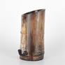 One of a series of vessel sculptures inspired by Nature. Natural vessel combining earthy elements of wood, metal, and stone crafted from sustainably harvested locally grown bamboo. Beautiful natural markings from growth preserved and enhanced with shou sugi ban (fire staining) technique. Copper metallic accents inspired by kintsugi (filling imperfections with precious metal). Natural quartz crystals wrapped in copper wire appear to be growing from the sheath scar at the base - a remnant of a branch.

5.875 inches H
3 inches W