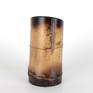 One of a series of vessel sculptures inspired by Nature. Natural vessel combining earthy elements of wood, metal, and stone crafted from sustainably harvested locally grown bamboo. Beautiful natural markings from growth preserved and enhanced with shou sugi ban (fire staining) technique. Copper metallic accents inspired by kintsugi (filling imperfections with precious metal). Natural quartz crystals wrapped in copper wire appear to be growing from the sheath scar at the base - a remnant of a branch.

5.875 inches H
3 inches W