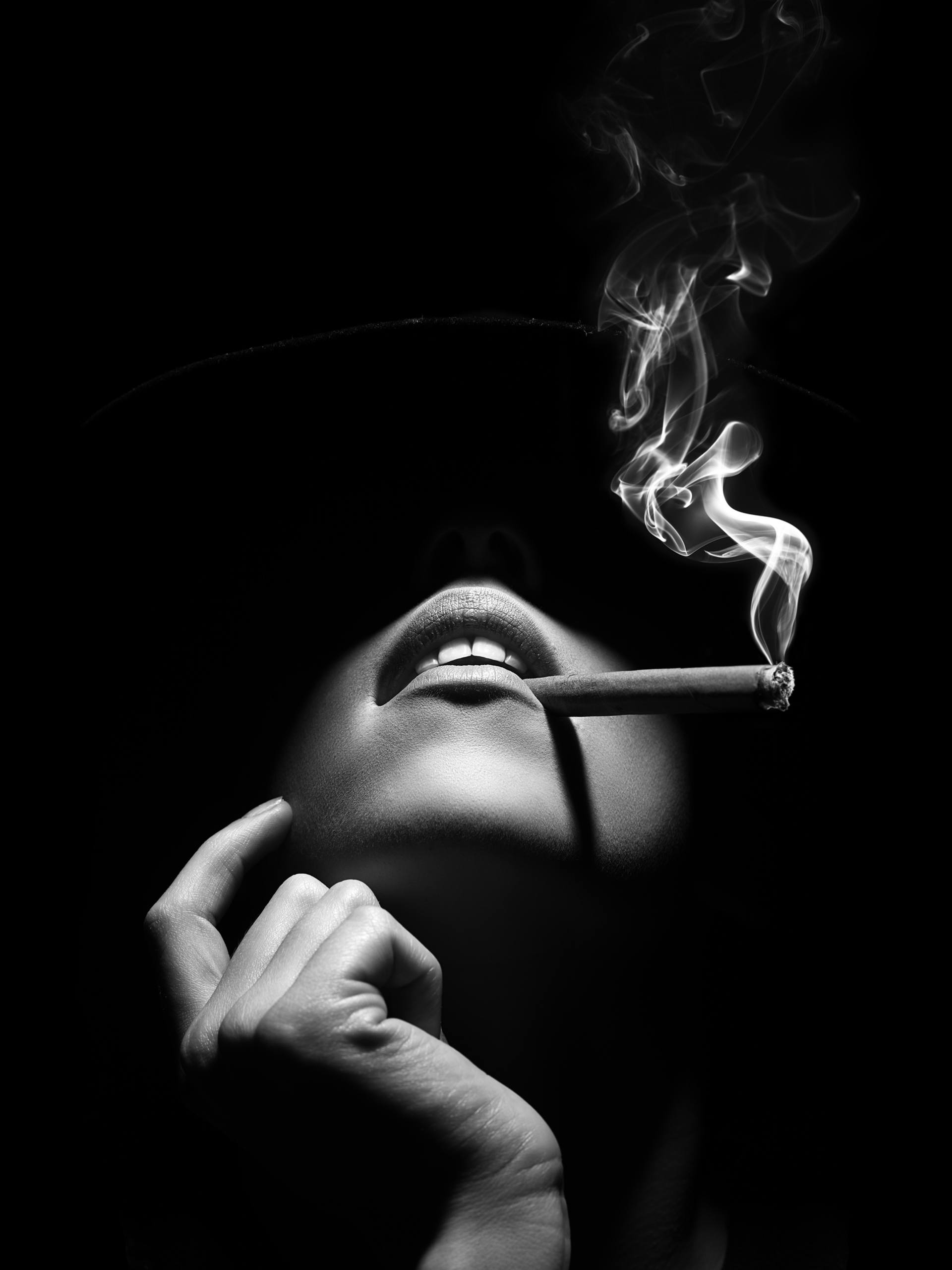 Woman smoking a cigar Photography by Johan Swanepoel