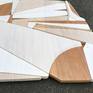 Leisure Class is a discreet and elegant minimalist contemporary wall sculpture. It is constructed with  birch panels, acrylic washes and completed with a hand waxed finish. The acrylic wash allows the wood grain to show through the paint and creates an almost marble-like appearance as the warm brown wood grain shows through the gradient white tones. Leisure Class is a piece that focuses on the composition, balance, and form by using a limited monochrome color palette. The piece diffuses multiple opacities of white creating a contemplative state or alluding to an upbeat fresh or coastal modern vibe.