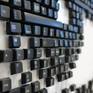 Modern wallart sculpture. Artwork made from computer keyboard keys on white plastic panels. A 266 x 76 cm artwork is cut into three panels.
