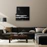 Painting hung with dark sofa and lamp
