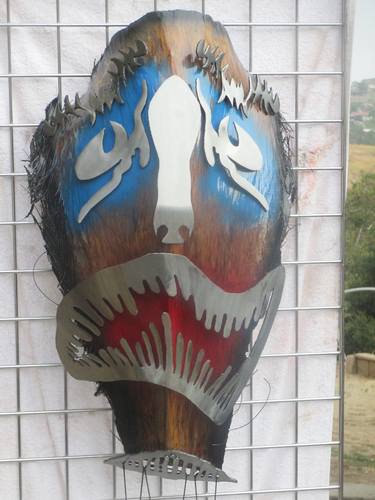 "Blue Eye's Crying" wall hanging mask and "5 Wind Chimes" hang from bottom thumb