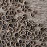 This is a woven piece with a silk warp. The weft is based of a cotton-silk yarn, fique (a sturdy plant fiber) and hand made ceramic buttons.