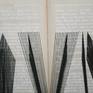 The sentence "OLTRE L'ATTIMO" is made with black threads on two old books.
