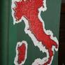 A map of Italy composed by nails and threads on an old register. The colors refer to the Italian flag
Time lapse video: https://www.facebook.com/dadoschapira/videos/1299690270205935/