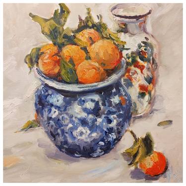 Fresh mandarin oranges in a blue pot thumb