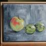 Still life with apple and limes, painted from life with abstract background.  Oil on linen.  Measures 10 by 13 inches framed.  Artwork sold framed.