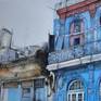 Colonial building in Old Havana painted in striking blue color that shows the state of neglect and lack of maintenance.