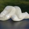 A reclining nude from white albaster stone.Inspired by the shapes off the woman body. The detail  is hereby subordinated to the shape. Albaster is a white ,more or less tranculent, stone.