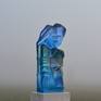 This is a kiln casted sculpture. Made with three different colours of blue . The sculpture is flat on the back  but it is transparant so you see the figures with depth on the backside.( see the detail pictures) The base is made of natural stone and is polished. Base 1,2 h 2 d. 3,5w.
The  base is polished. Ihave  made a mold of this sculpture so I made different colours. It is 21 cm high and the glass is 3cm. thick.