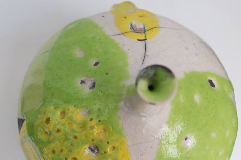 Raku and black smoked vessel with green and yellow glaze