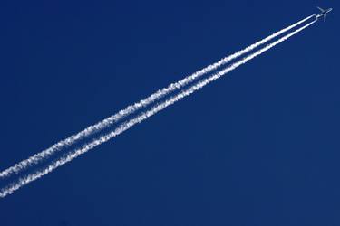 Clear blue sky cut by Airplane trails thumb