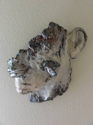 Raku face with moth thumb