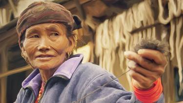 Nepalese woman weaving wool thumb