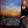 Artist, Cherie Roe Dirksen, with her painting