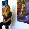 Cherie Roe Dirksen at her exhibition with 'Chaoskampf Demiurge' in the background