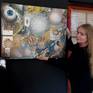 Cherie Roe Dirksen with her painting to show the scale