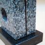 signature on sleek black granit base
