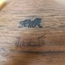 An upside down look at the bottom, showing artist signature and trade mark.