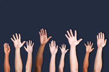 Diverse group of raised hands thumb