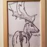 Print framed; zoomed in on deer.