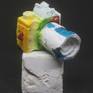 A camera sculpture of textured concrete, sandstone and acrylic, sits on a textured concrete base.

Limited Edition.

“The camera is an instrument that teaches people how to see without a camera.”
— Dorothea Lange