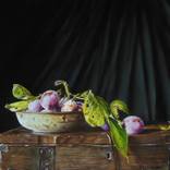 Plums in a rusty dish on a box by Jan Teunissen