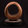 This warm, sensuous walnut sculpture comes with a stone stand. Each and every perspective lends a slightly different melody.