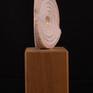 This small abstract sculpture, of beautiful Red Portuguese Alabaster, consists of concentric circles and varying textures--from rough to highly polished.  There is a recess for a pin for mounting on a stand.