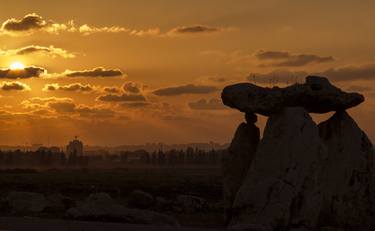 Big stones and Sunset over the city skyline. thumb